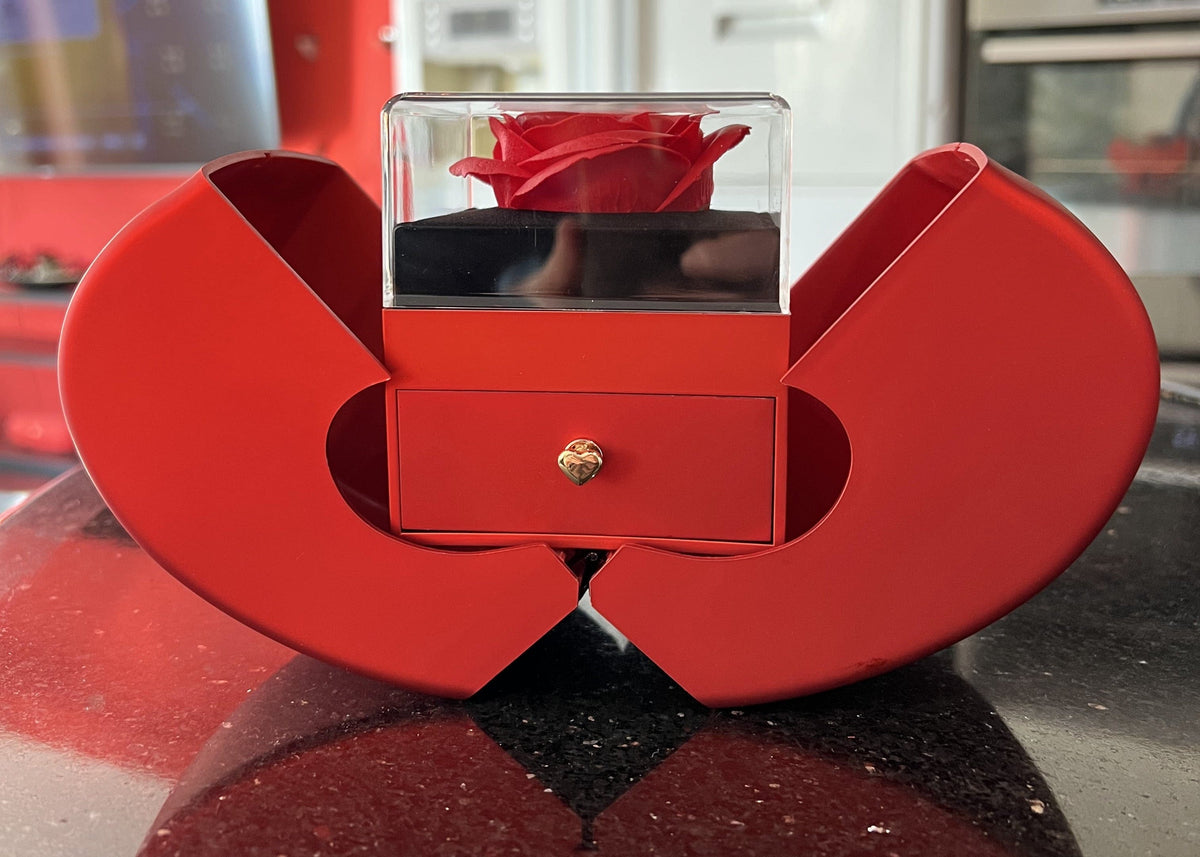 Red heart box with a soap rose under a clear cover and a small drawer in front