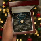 Mahogany style box with LED light holding the love knot pendant necklace in 18k yellow gold finish and the "To My Daughter" message card from Dad (Never Forget That I Love You)