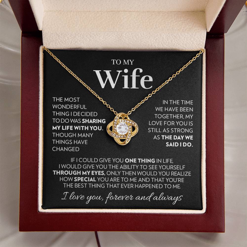 Mahogany style box with LED light holding the love knot pendant necklace in 18k yellow gold finish and the "To My Wife" message card from husband