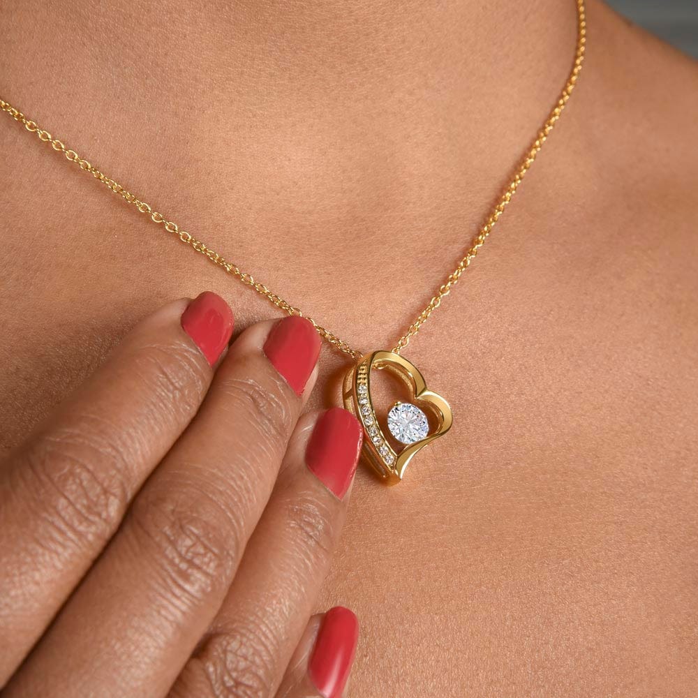 Heart pendant necklace in 18k yellow gold finish worn by a woman