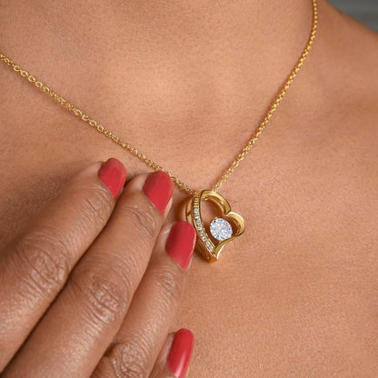 Heart pendant necklace in 18k yellow gold finish worn by a woman
